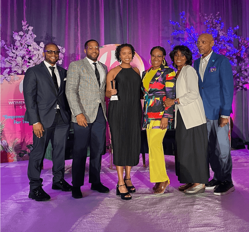 img-1 Tonya standing with a group of people on stage